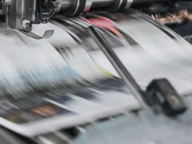 Printed sheets running through a press