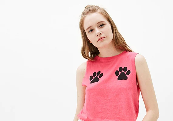 Young woman in a pink tank top with paw prints