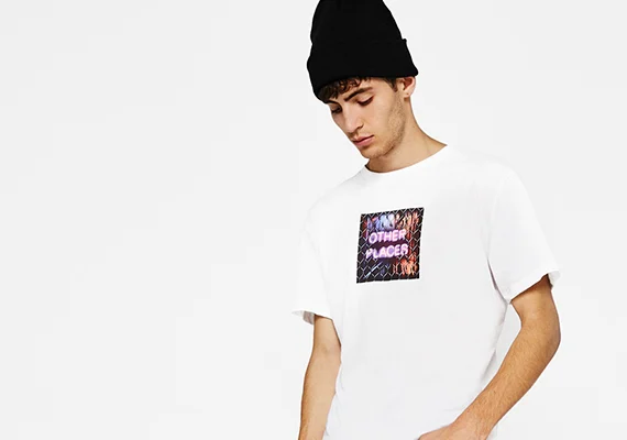 Man in a white tee with a square graphic print