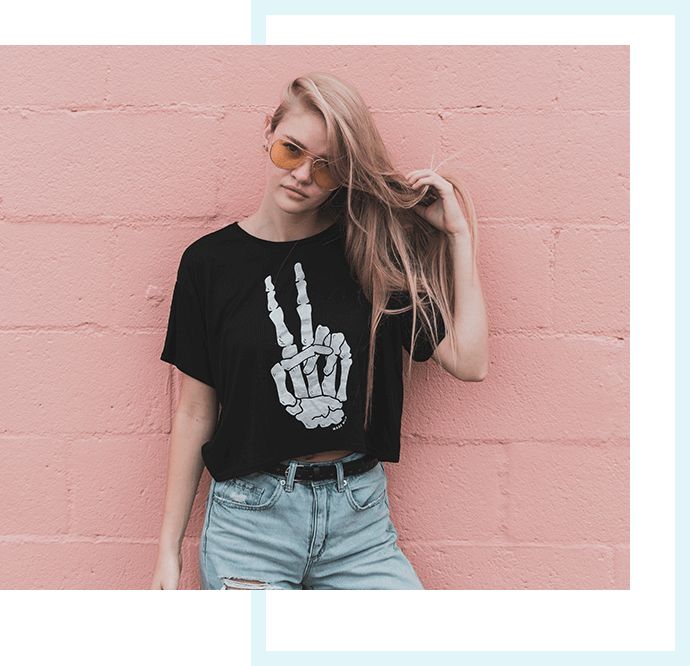 Woman in a black printed tee in front of a pink wall