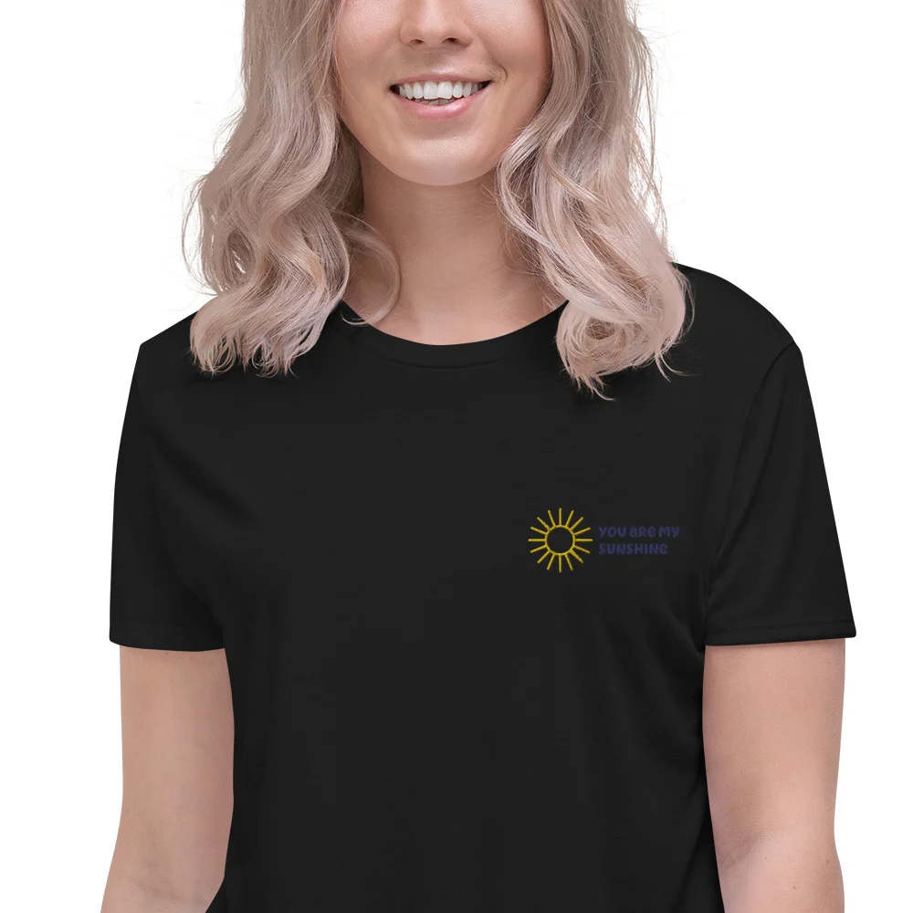 Close-up of the embroidery on a black crop tee
