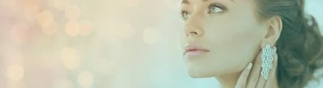 Woman with a drop earring in warm light
