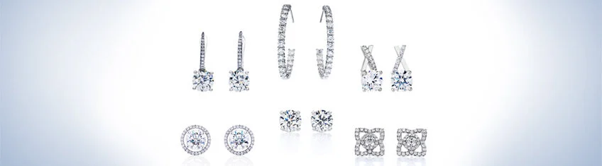 Diamond earrings in a row on a light background