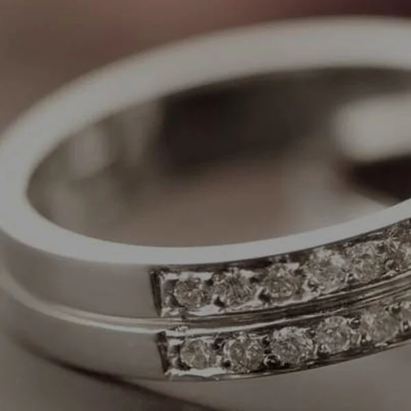 Two stacked silver bands, close up