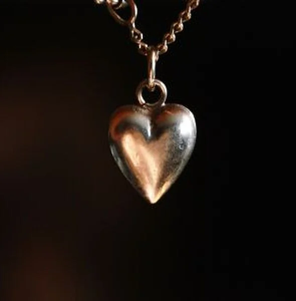 Small puffed heart pendant on a fine chain