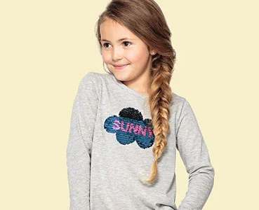 Girl in a grey long sleeve top with a sequin cloud print