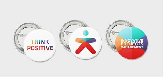 Three printed button badges